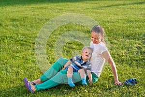 Happy woman and child having fun outdoor on meadow