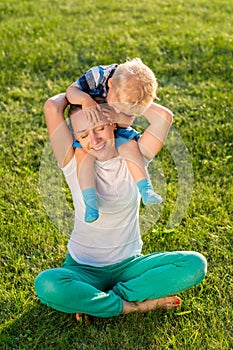 Happy woman and child having fun outdoor on meadow