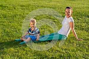 Happy woman and child having fun outdoor on meadow