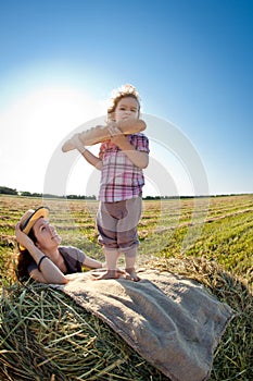 Happy woman and child in wheat field