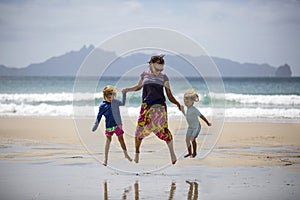 Happy woman and children on beach