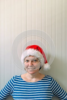 Happy woman with Christmas Santa Claus hat in cheerful mood