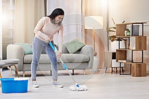 Happy, woman and cleaning floor in home with mop for hygiene with detergent for safety or protection from germs . Smile