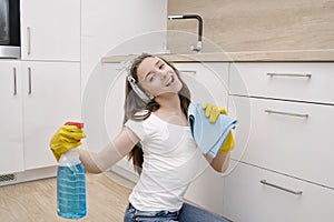 Happy woman cleaning home, singing . Housework, chores concept.Girl cleaning the house. House cleaning service.A beautiful