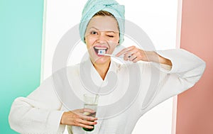 Happy woman cleaning teeth with toothbrush. Dental hygiene. Oral care. Winking girl brushing teeth.