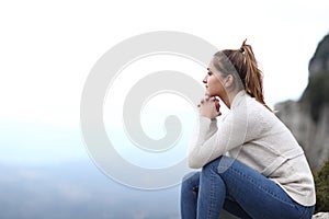 Happy woman contemplating views in the mountain