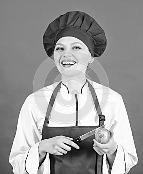 Happy woman cooking healthy food by recipe. Housewife with cooking knife and onion. professional chef in kitchen
