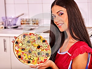 Happy woman cooking pizza