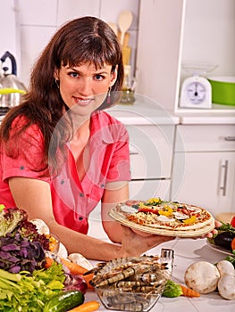 Happy woman cooking pizza