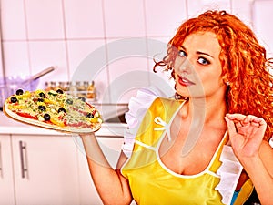 Happy woman cooking pizza