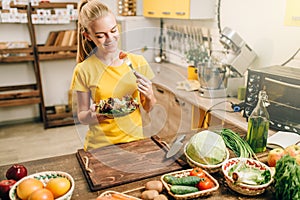 Happy woman cooking salad, bio food preparing