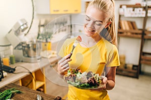 Happy woman cooking salad, bio food preparing