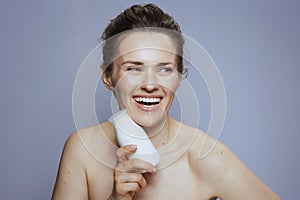 happy woman with cosmetic cream jar