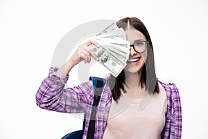 Happy woman covering her eyes with bills of dollar