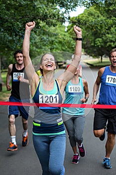 Happy woman crossing the finish line