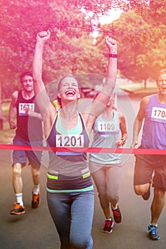 Happy woman crossing the finish line