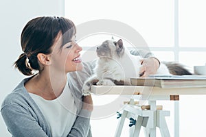 Happy woman cuddling her cat