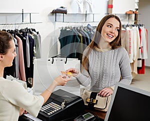 Happy woman customer paying with credit card