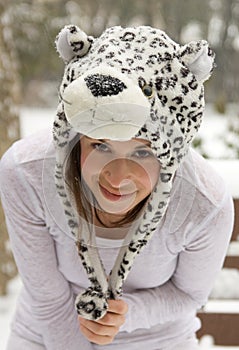 Happy Woman in Cute Animal Hat in Snow