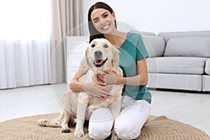 Happy woman with cute pet dog at home