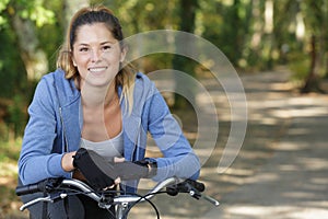 happy woman cyclist looking at camera