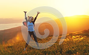 Happy woman dances, jump, rejoices, laughs on sunset in nature photo