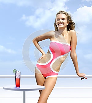 Happy woman on a deck takes sunbathing