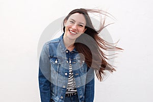 Happy woman in denim jacket with long hair blowing
