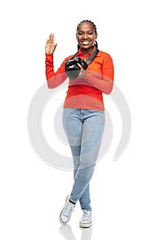 happy woman with digital camera waving hand