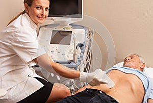 Happy woman doctor analyzing male patient with abdomen ultrasound