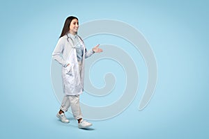 Happy woman doctor gesturing, casual attire with lab coat, free space