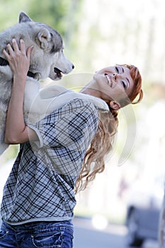 Happy woman with dog haski outdoors