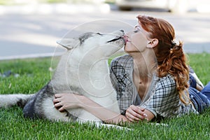 Happy woman with dog haski outdoors