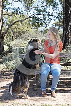 Happy Woman and Dog Resting in Park.