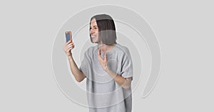 Happy woman doing video chat using mobile phone