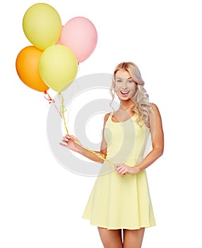 Happy woman in dress with helium air balloons