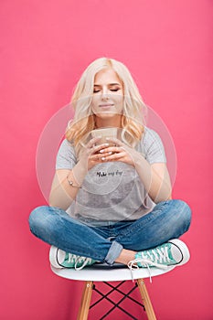 Happy woman drinking cappuccino