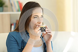 Happy woman drinking coffee enjoying flavour photo