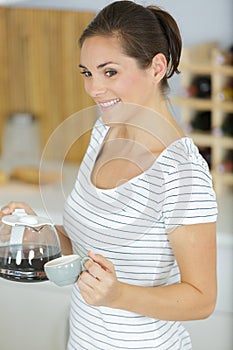 happy woman drinking coffee at home