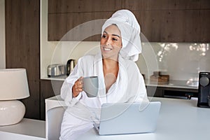 Happy woman drinking coffee at home