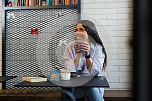 Happy woman drinking coffee in the morning at restaurant