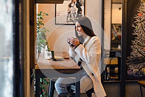 Happy woman drinking coffee in the morning at restaurant