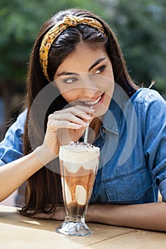 Happy woman drinking cold coffee