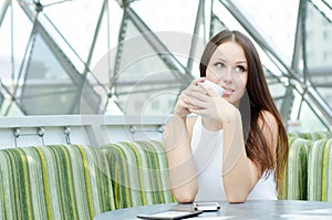 Happy woman drinking first cup of coffee