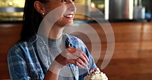 Happy woman drinking milkshake