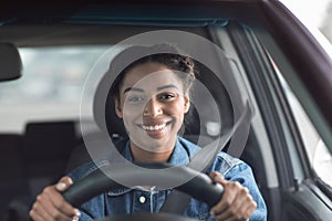 Happy woman driving car and smiling going to work or on road trip
