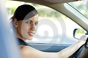 Happy woman driving her car