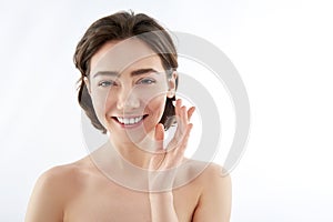 Happy woman with drop of cream on finger