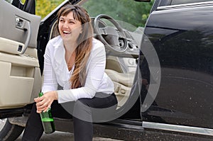 Happy woman drunkard in a car