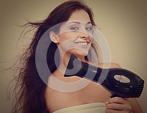 Happy woman drying long hair. Closeup